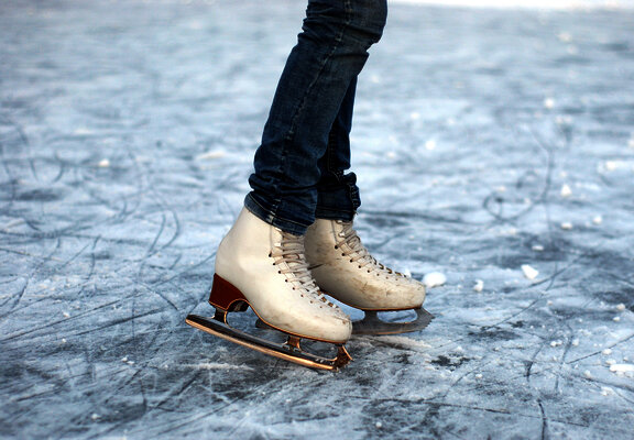 Das Bild zeigt eine Schlittschuhläuferin auf dem Eis.